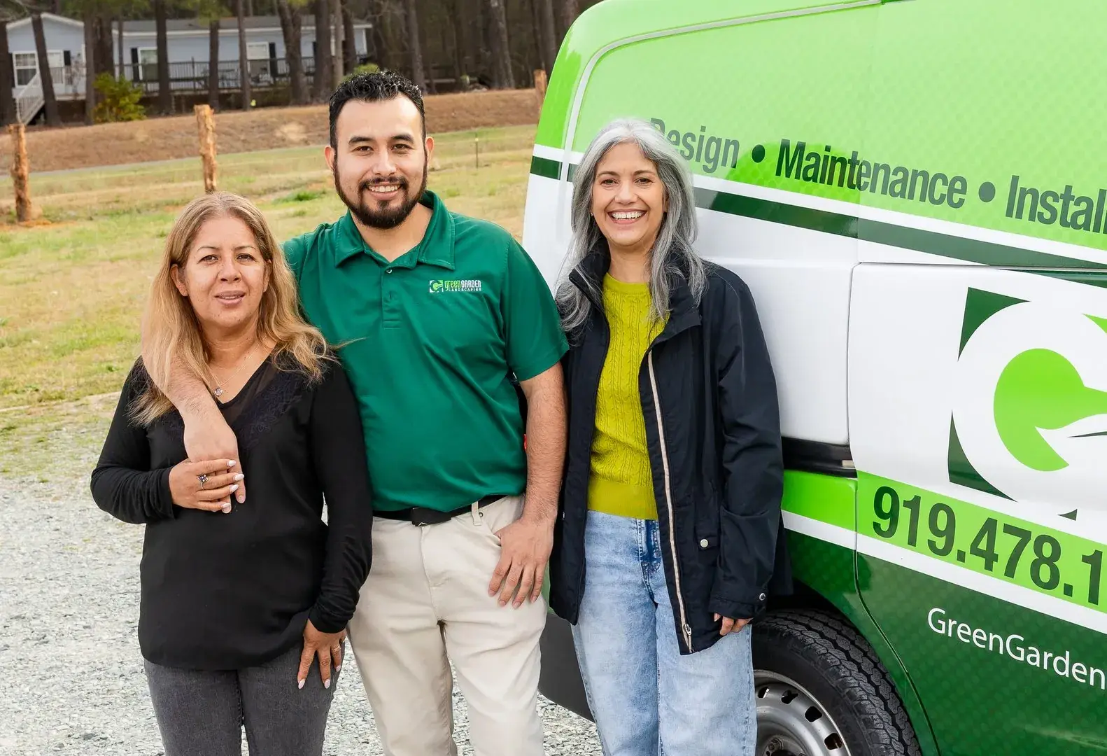 Green Garden Landscaping team in front of the branded wrapped van