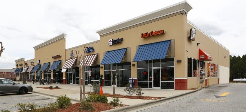 Commercial landscape maintenance with clean beds and trimmed shrubs