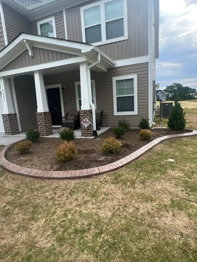 House front entry with professional landscaping and mulch beds in Sanford NC