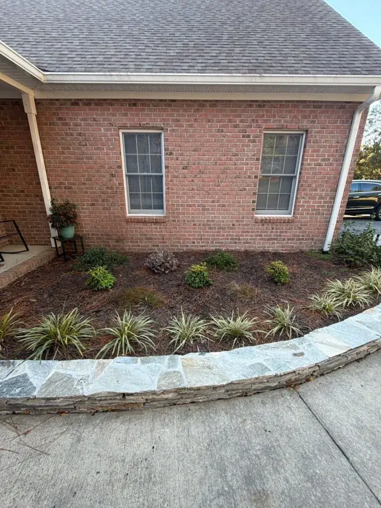 Brick retaining wall with professional landscape installation in central NC